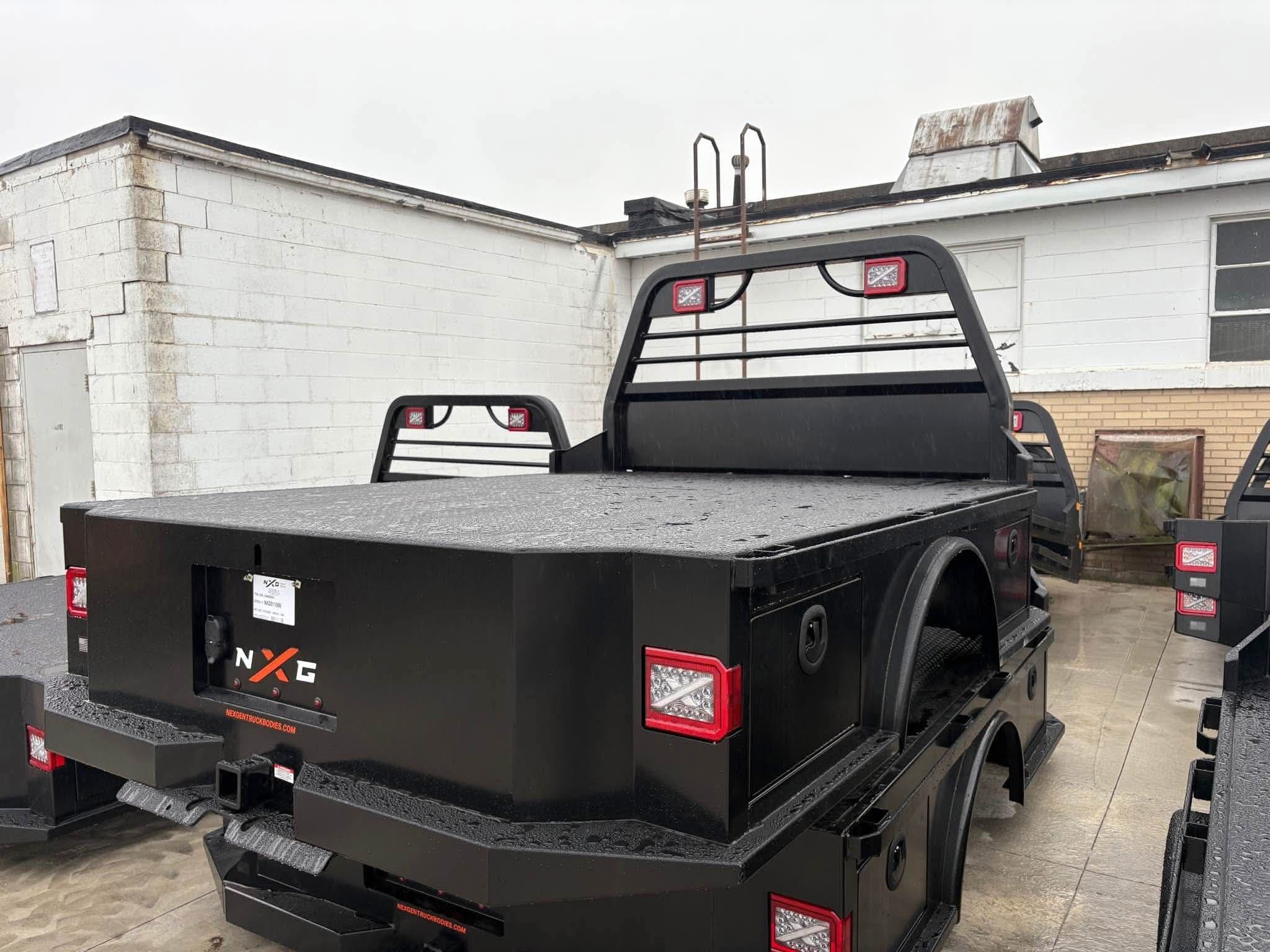 Driver-side angle of the NXG XSD skirted flatbed showing the full-length deck and side compartment doors
