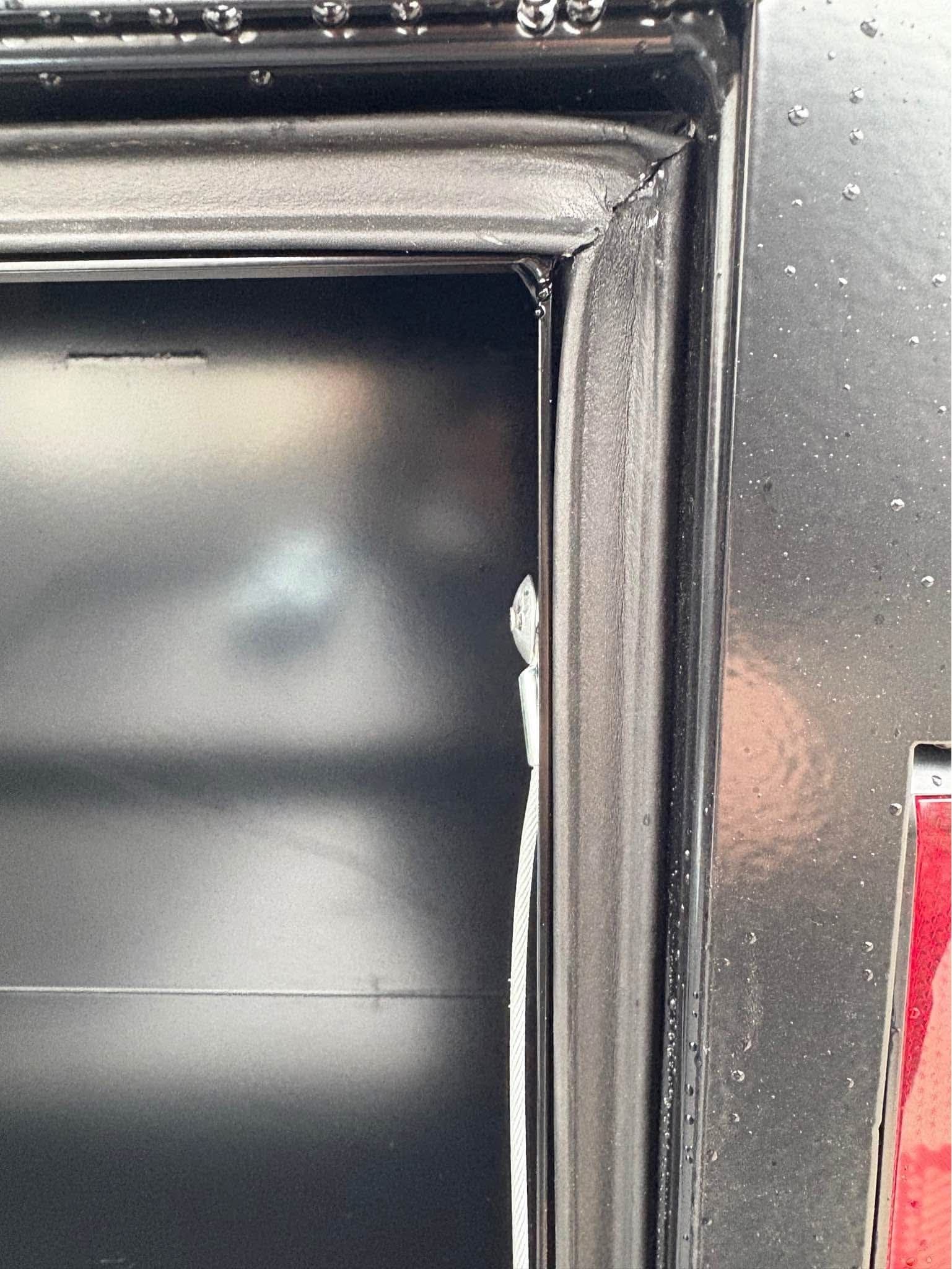 Close-up of an NXG toolbox door frame showing the weather stripping mitered into the corner